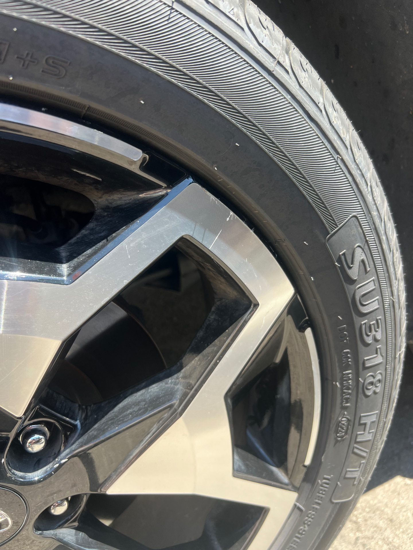 Close view of new passenger tire sidewall and rim finish